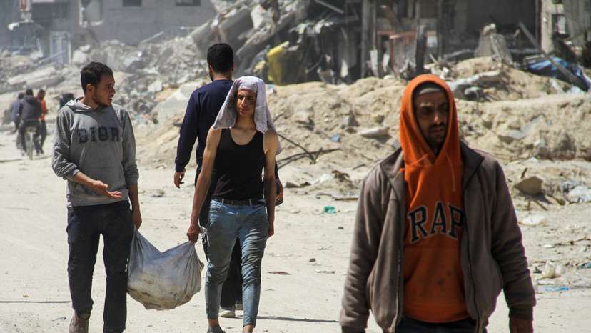 Palestinians gather in hope of receiving aid in Gaza City