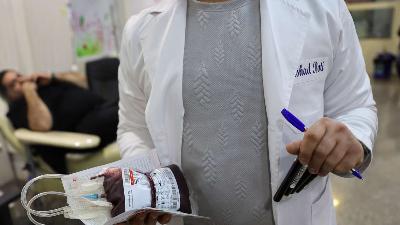 A medical worker holds a bag with donated blood, amid the U.S.-Israeli conflict with Iran, in Tehran