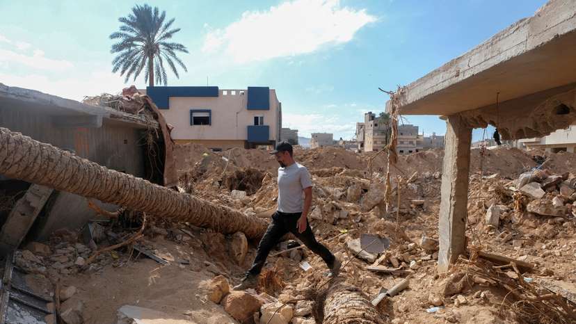 FILE PHOTO: Abdul Salam Ibrahim Al-Qadi, 43 years old, walks on the rubble in front of his house, searching for his missing father and brother after the deadly floods in Derna