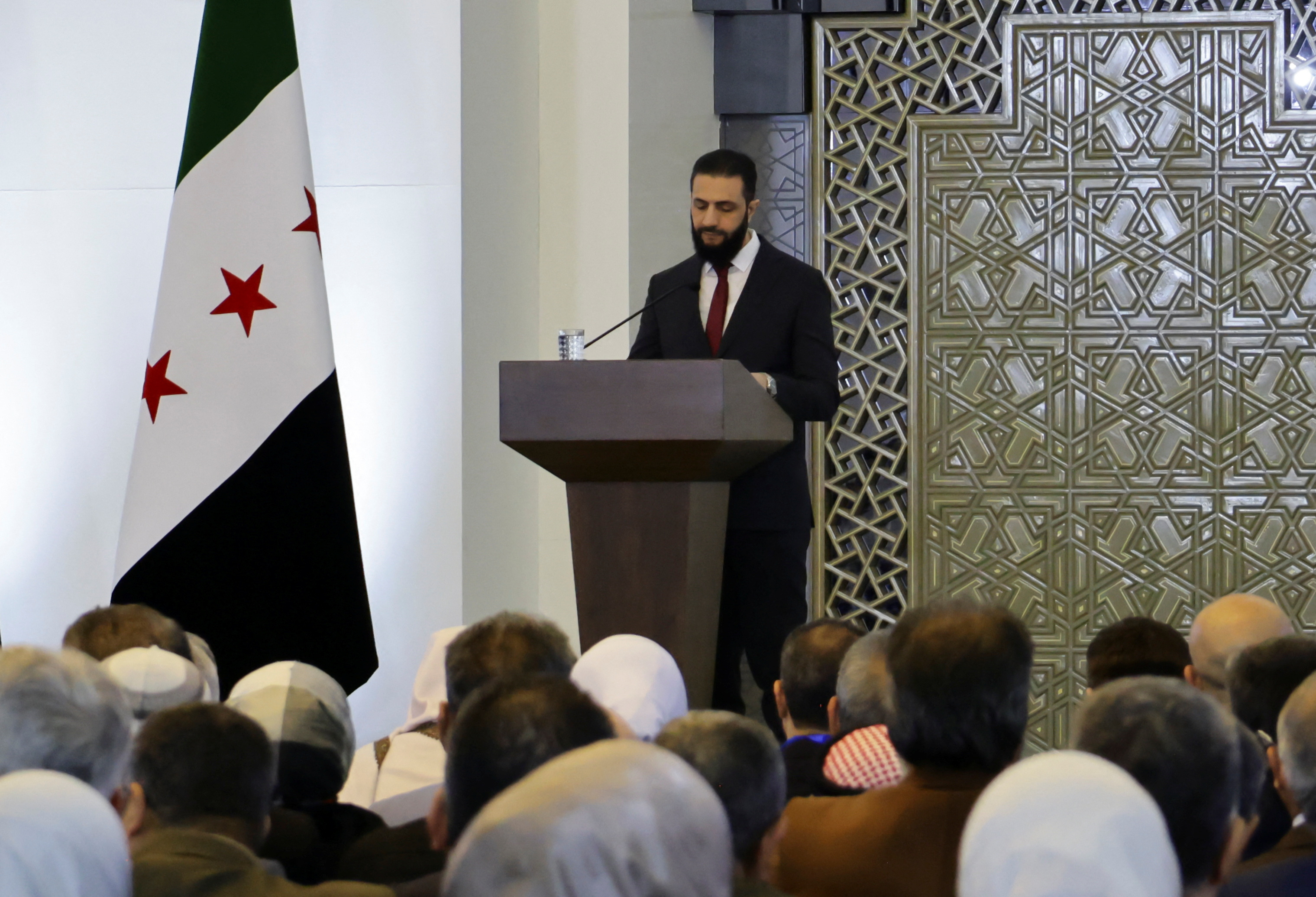 Syria's interim President Ahmed al-Sharaa speaks during a national dialogue, in Damascus