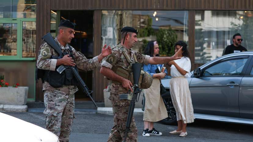 Lebanese army soldiers gesture as they secure the area near the U.S. embassy in Awkar