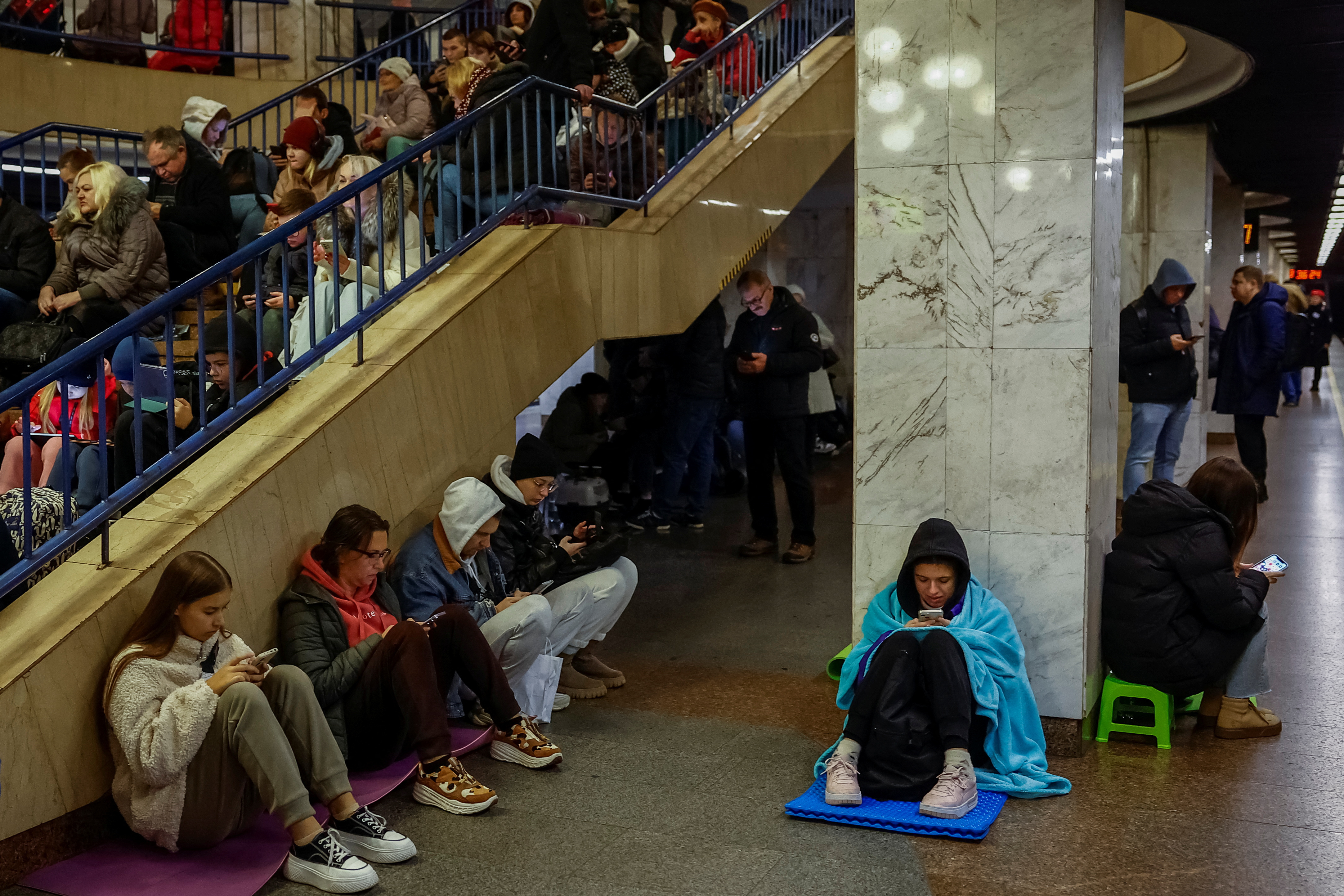 People take shelter inside a metro station during an air raid alert in Kyiv