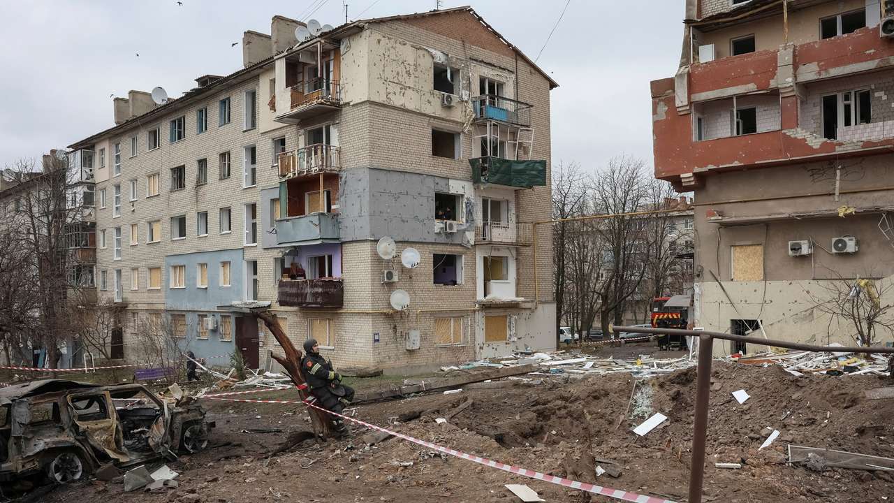 A firefighter rests at the site of apartment buildings hit by Russian missile strikes in the town of Balakliia
