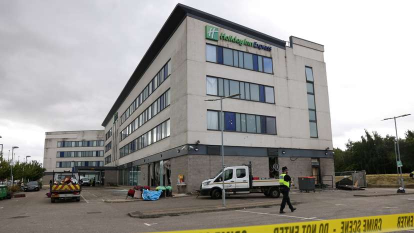 Clean up outside the Holiday Inn Express after rioters attacked the hotel in Rotherham