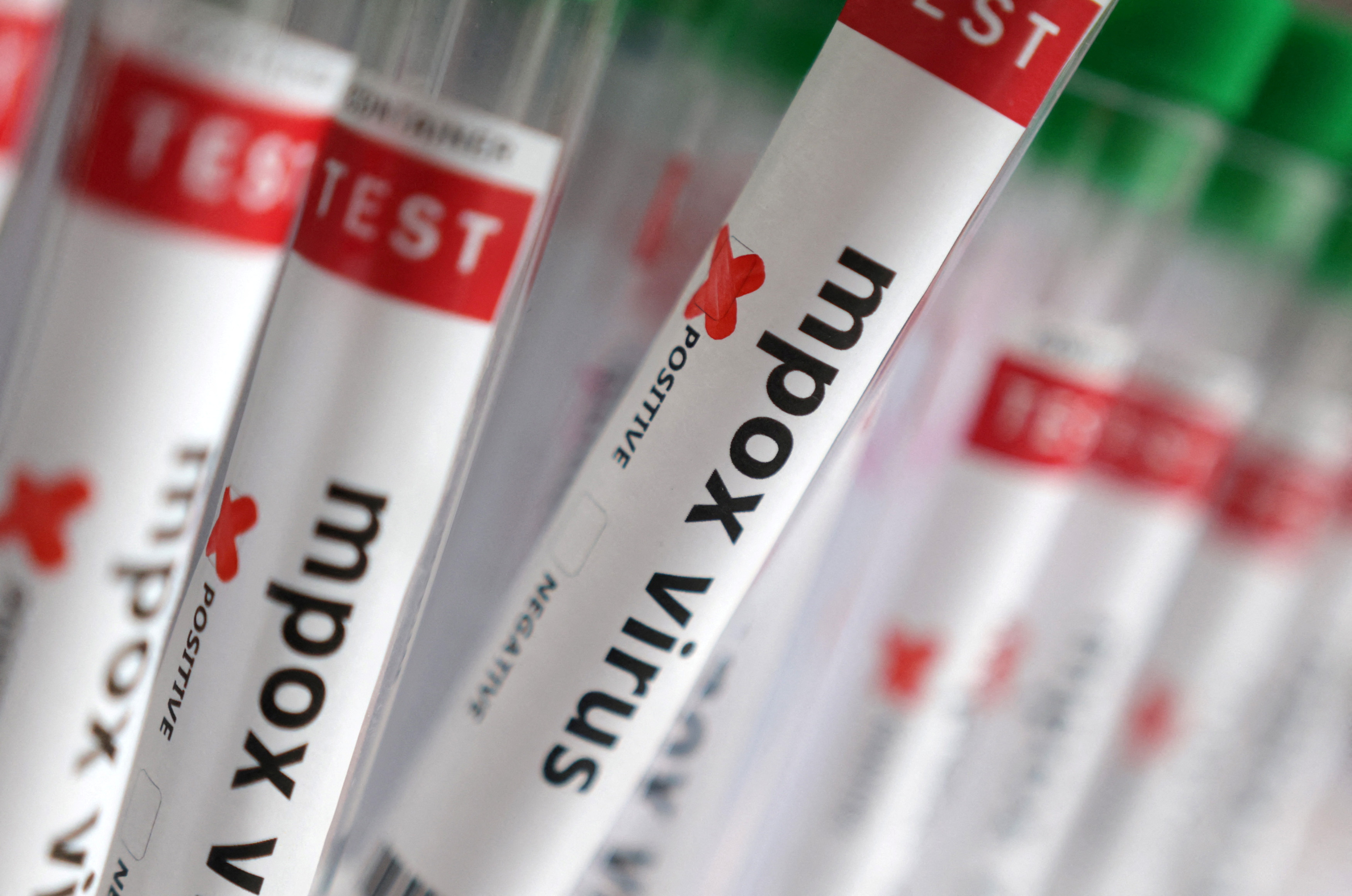 Illustration shows test tubes with "Mpox virus positive" label