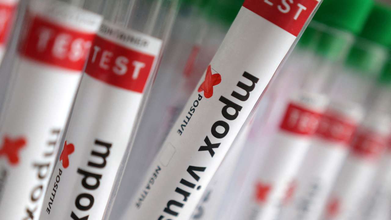 Illustration shows test tubes with "Mpox virus positive" label