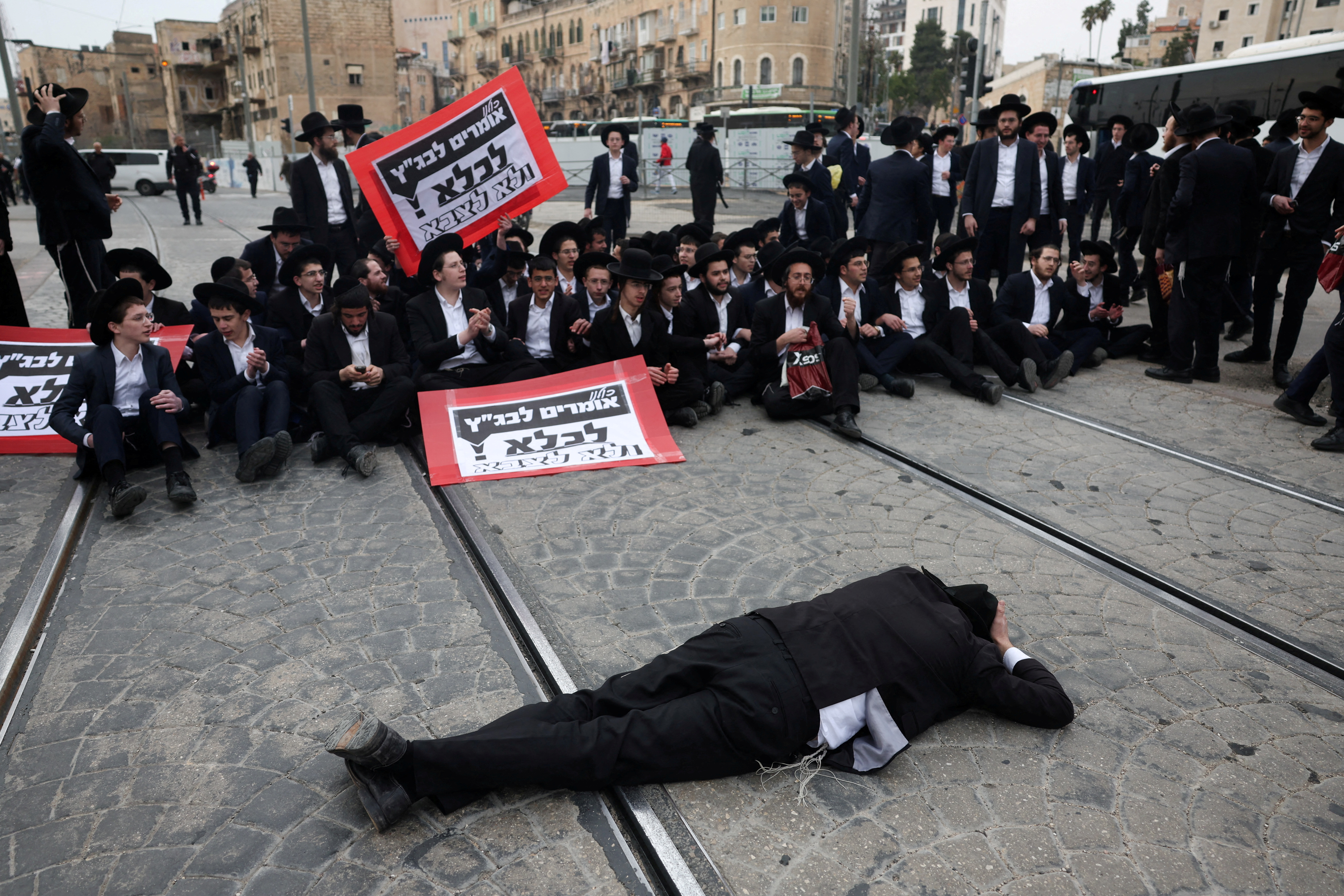 FILE PHOTO: Ultra-Ortodox Jewish men protest against attempts to change government policy that grants ultra-Orthodox Jews exemptions from military conscription, in Jerusalem