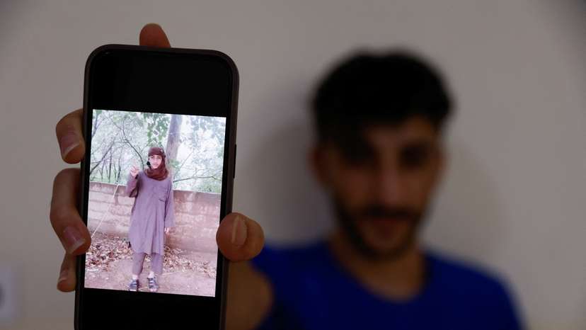 Fahad Qasim, 21, Yazidi survivor displays a picture taken during the time he was kidnapped by Islamic state in Syria, in Duhok