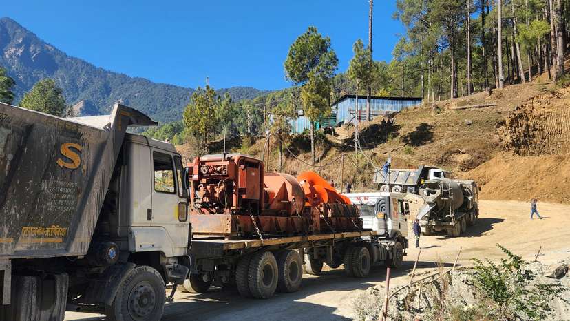 A new auger machine arrives at the site where road workers are trapped in a tunnel after a portion of it collapsed, in Uttarkashi