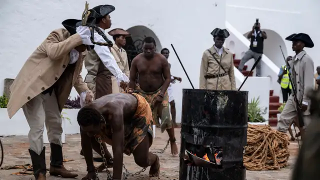 Students perform a reenactment of the slave trade at the University of Ghana Theatre Arts at the Christiansborg castle, former slave dungeon, in Accra