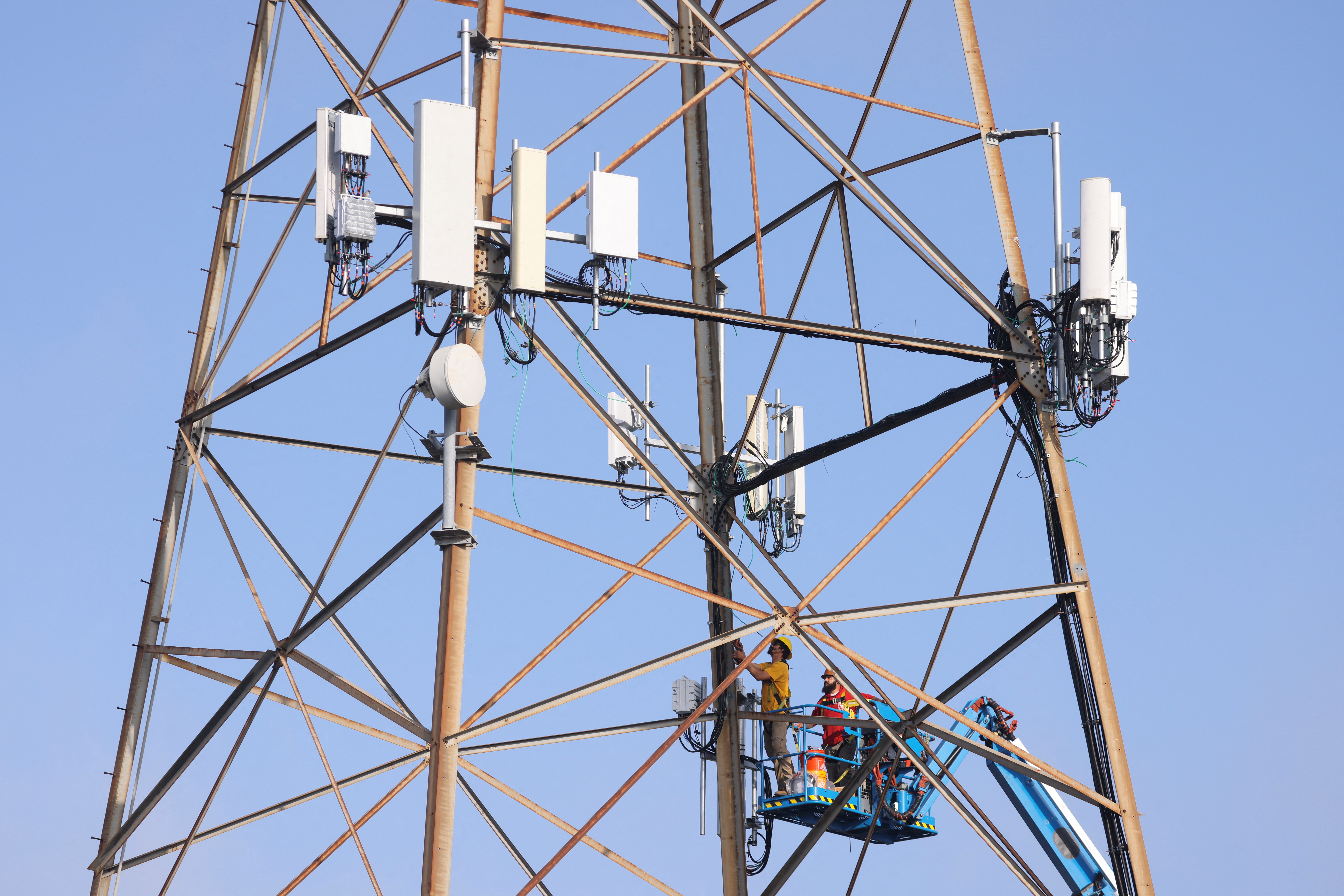 Technicians install 5G equipment in California