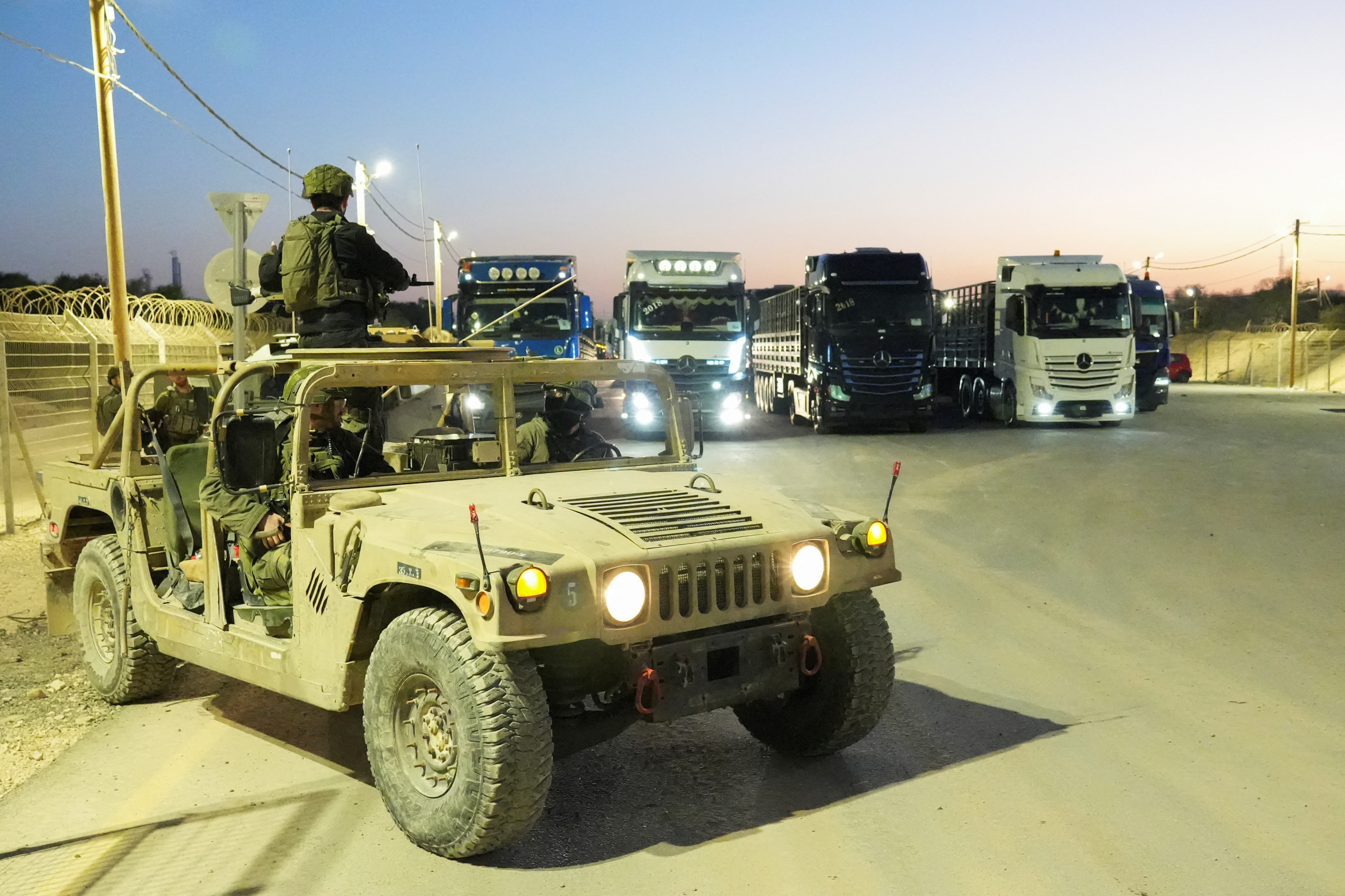 Trucks carrying humanitarian aid make their way to the Gaza Strip at Erez Crossing in southern Israel