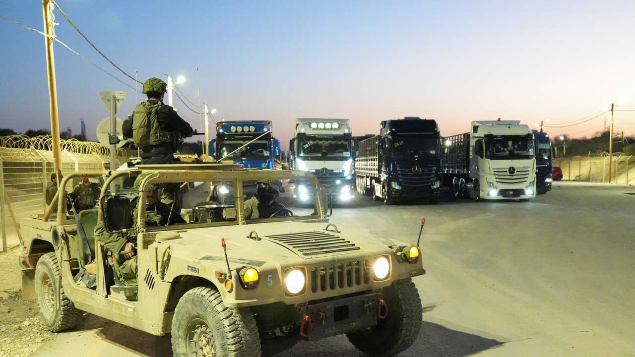 Trucks carrying humanitarian aid make their way to the Gaza Strip at Erez Crossing in southern Israel