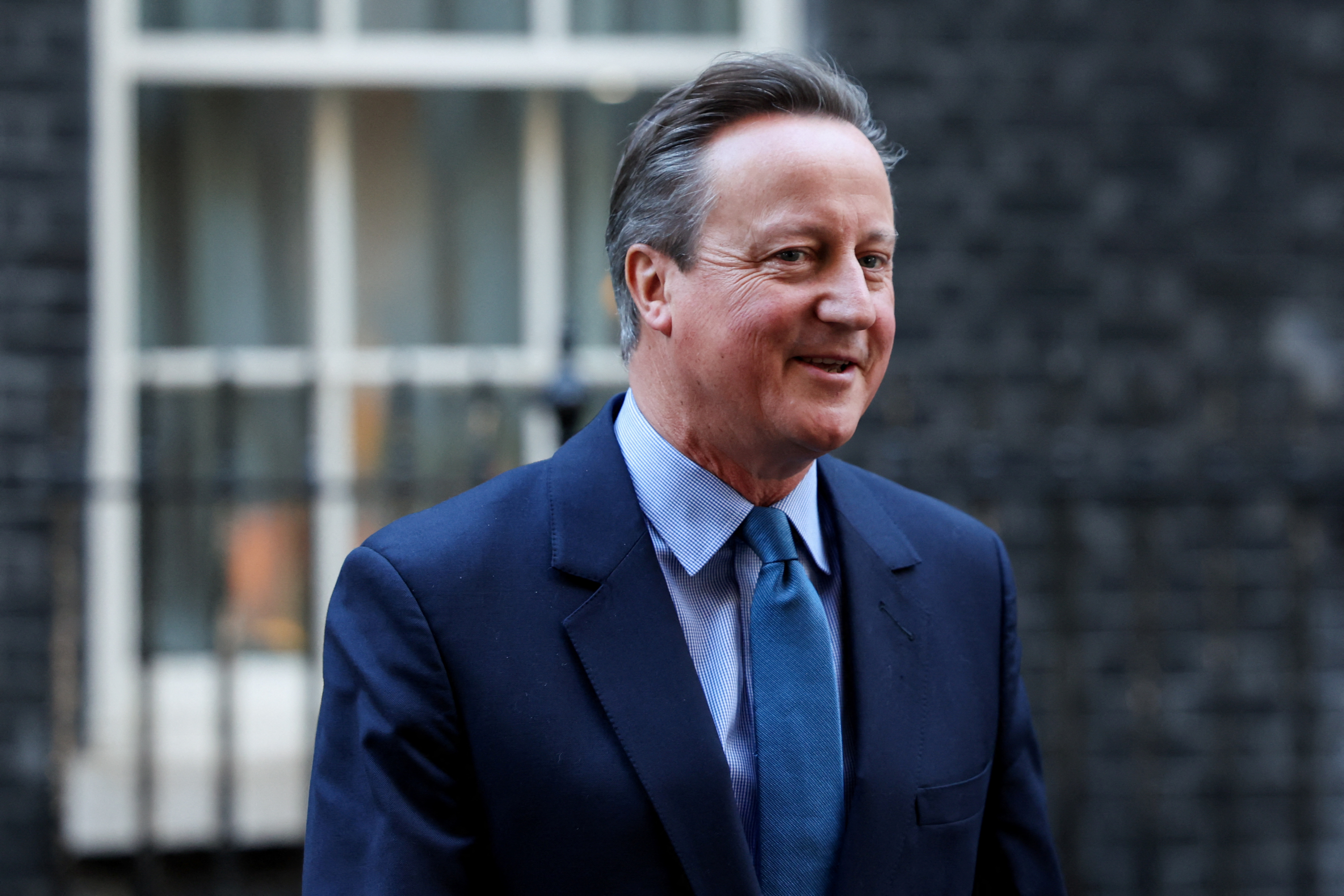 Britain's former Prime Minister and newly appointed Foreign Secretary David Cameron walks outside 10 Downing Street in London