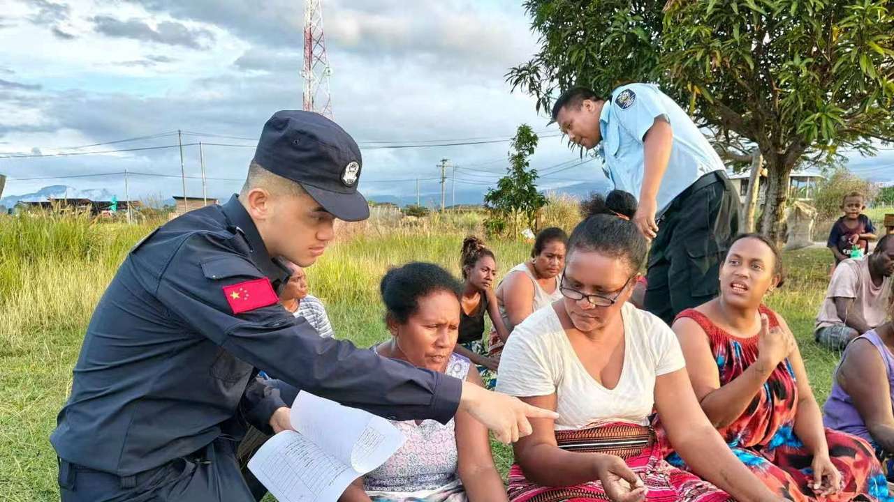 Members of the Royal Solomon Islands Police Force and China Police Liaisons interact with local members of the Fighter One community