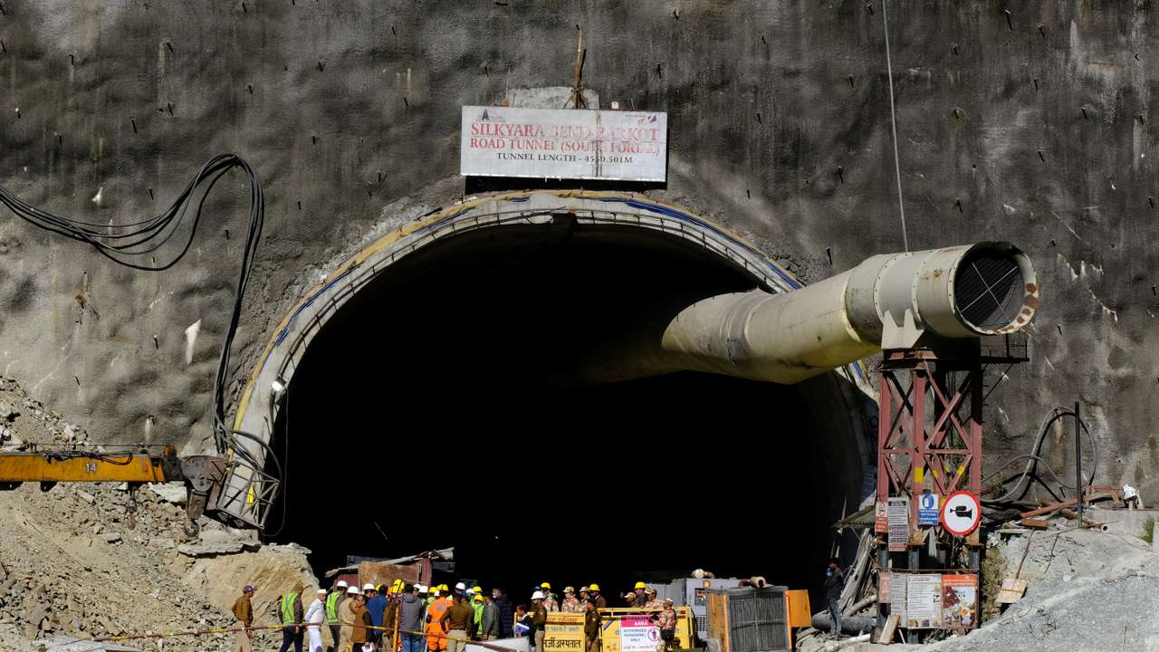 Members of rescue teams stand at the entrance of a tunnel where 40 road workers are trapped after a portion of the tunnel collapsed, in Uttarkashi