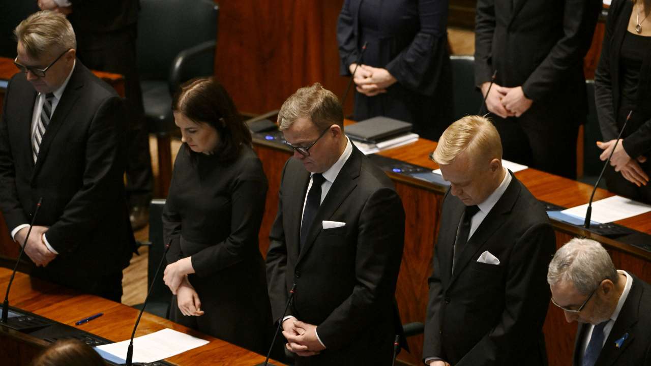 Members of the Finnish parliament pay their respect to the victims of the school shooting ahead of the parliament session, in Helsinki