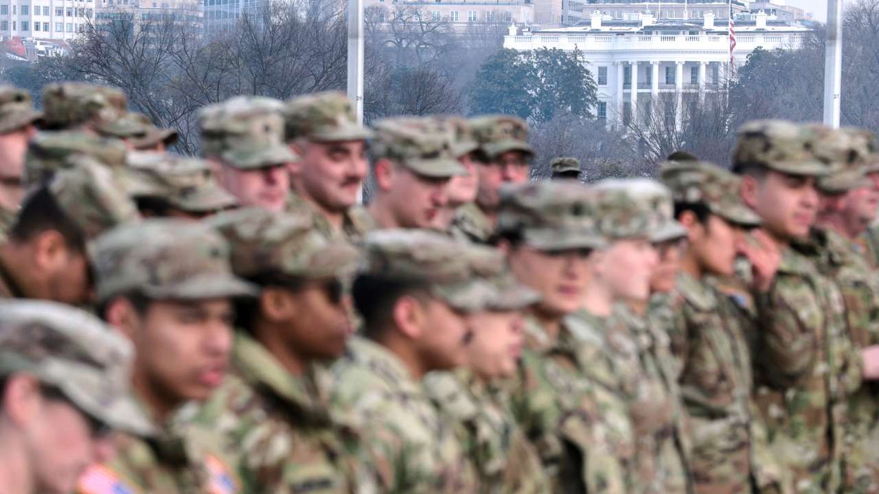 The White House is seen in the background as U.S. Army National Guard soldiers gather for U.S. Defense Secretary Pete Hegseth to administer their oath at a re-enlistment ceremony at the base of the Washington Monument in Washington, D.C., U.S., February 6, 2026. REUTERS/Jonathan Ernst