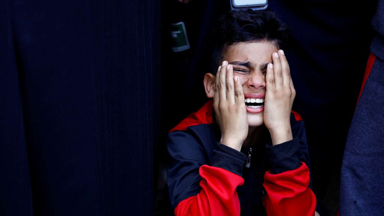 Palestinians react at a hospital, amid the ongoing conflict between Israel and Palestinian Islamist group Hamas, in Khan Younis