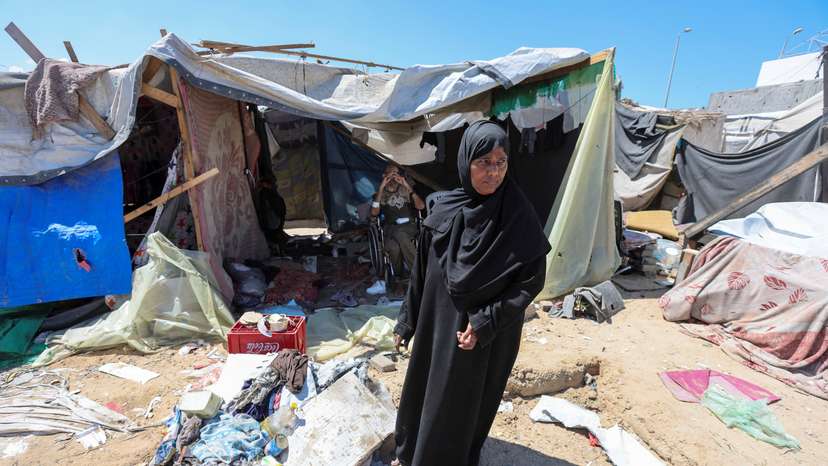 Displaced woman Iqbal Al-Zeidi stands in front of her tent which was torn by an Israeli strike, on the courtyard of Al-Aqsa Martyrs hospital, amid the Israel-Hamas conflict, in Deir Al-Balah