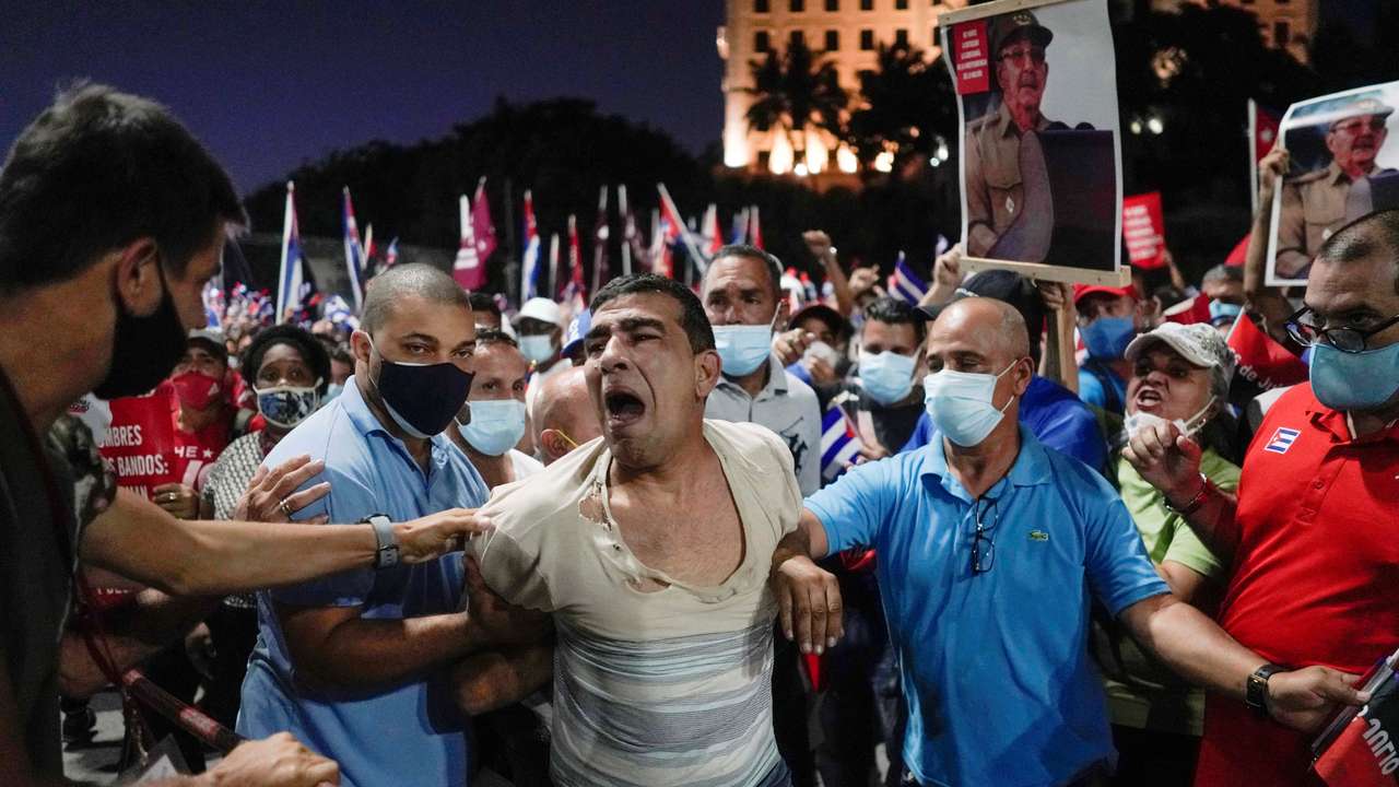 FILE PHOTO: People detain a protester during a rally in Havana