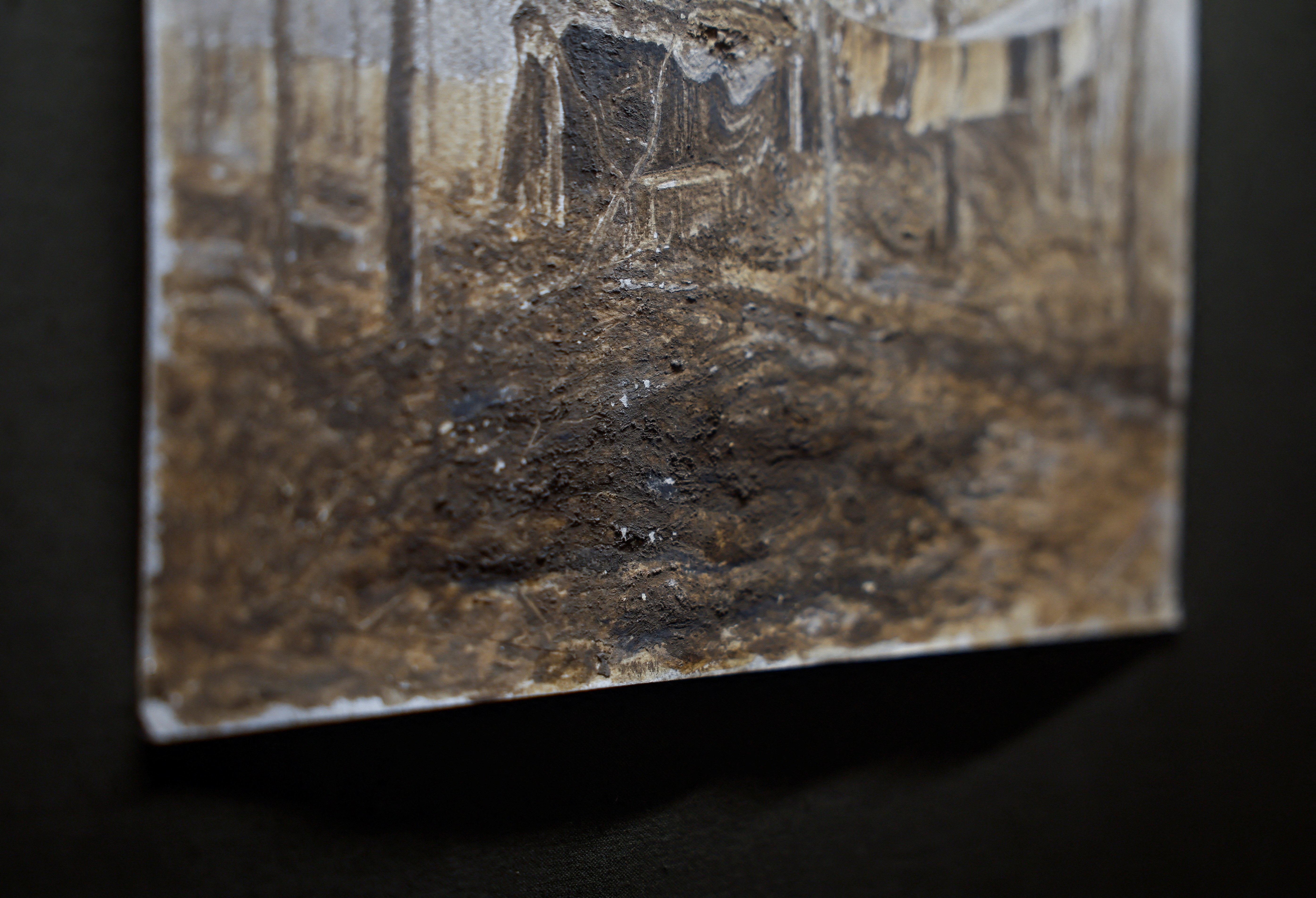 Trench mud is visible on a fragment of a painting displayed at the exhibition of a Ukrainian serviceman Bazylewicz with draws pictures with mud, clay and ashes from a frontline in Kyiv