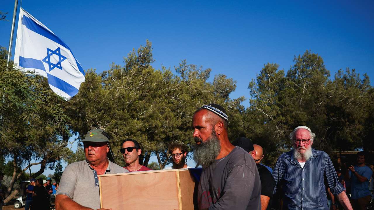 Mourners pay their respects to Yoram Metzger, at his funeral in Kibbutz Nir Oz