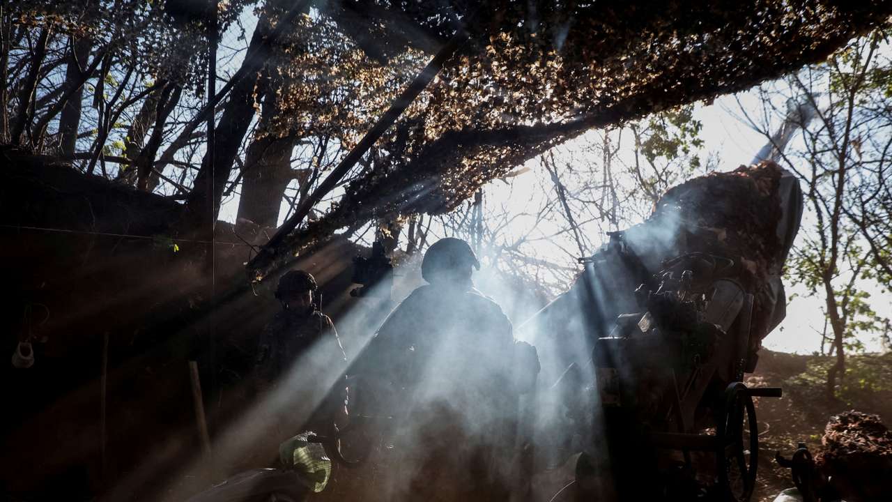 Ukrainian servicemen fire a howitzer towards Russian troops in Donetsk region