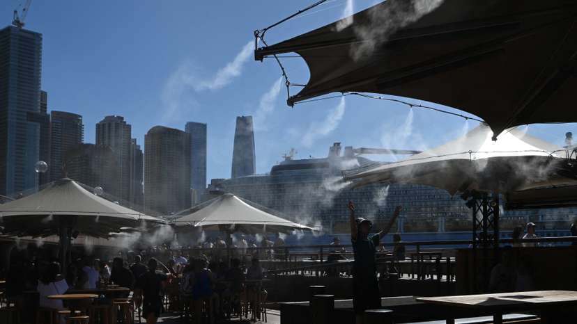 People cool off under a water mist at Circular Quay