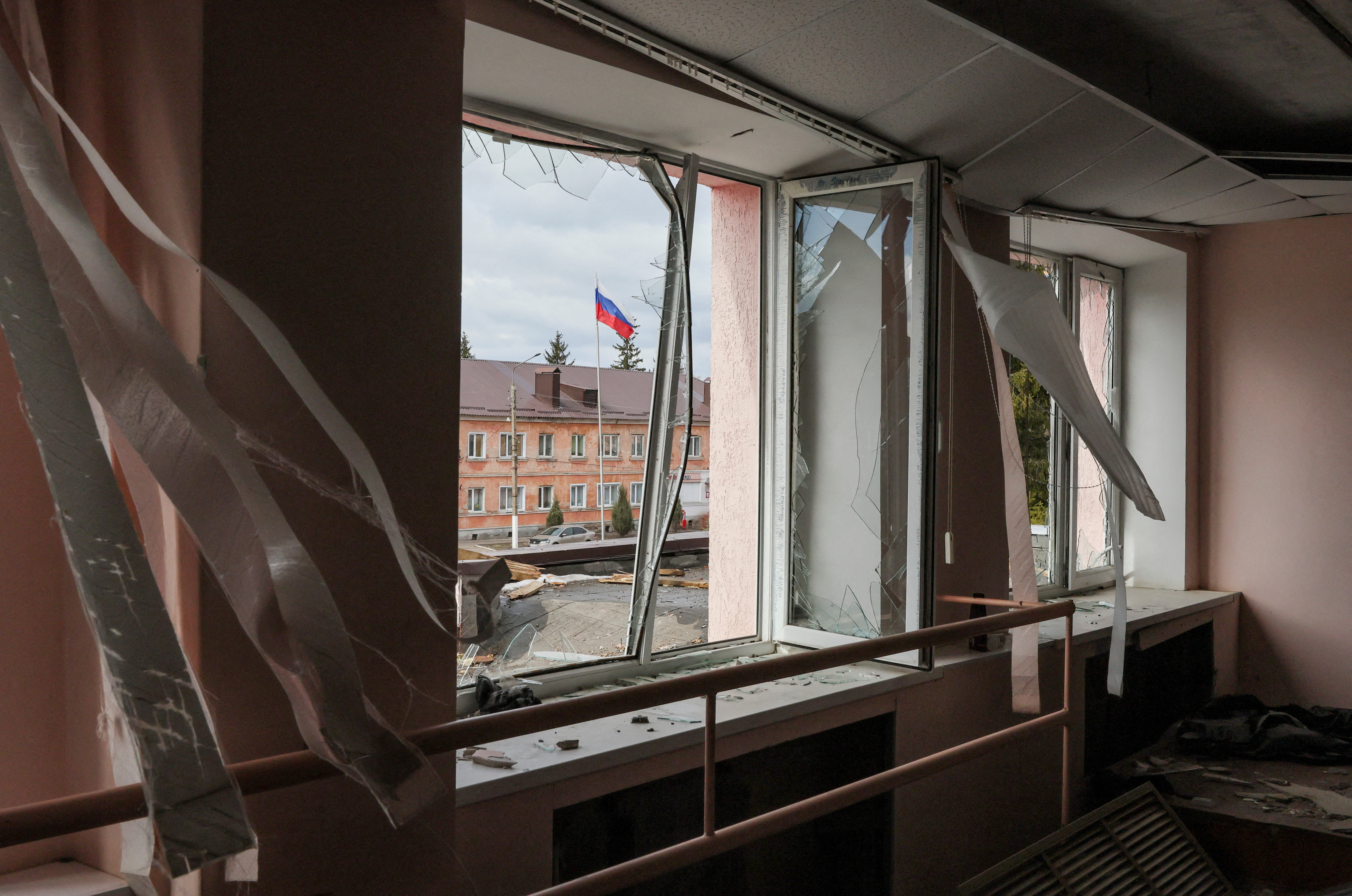 A Russian flag flies in front of a culture centre damaged by a missile attack in the town of Rylsk