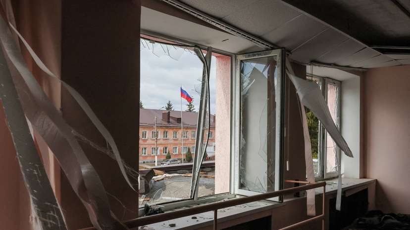 A Russian flag flies in front of a culture centre damaged by a missile attack in the town of Rylsk