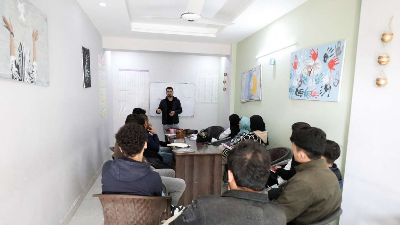 Afghan citizens, who are in the process for resettlement in the U.S. attend English language class on the outskirts of Islamabad