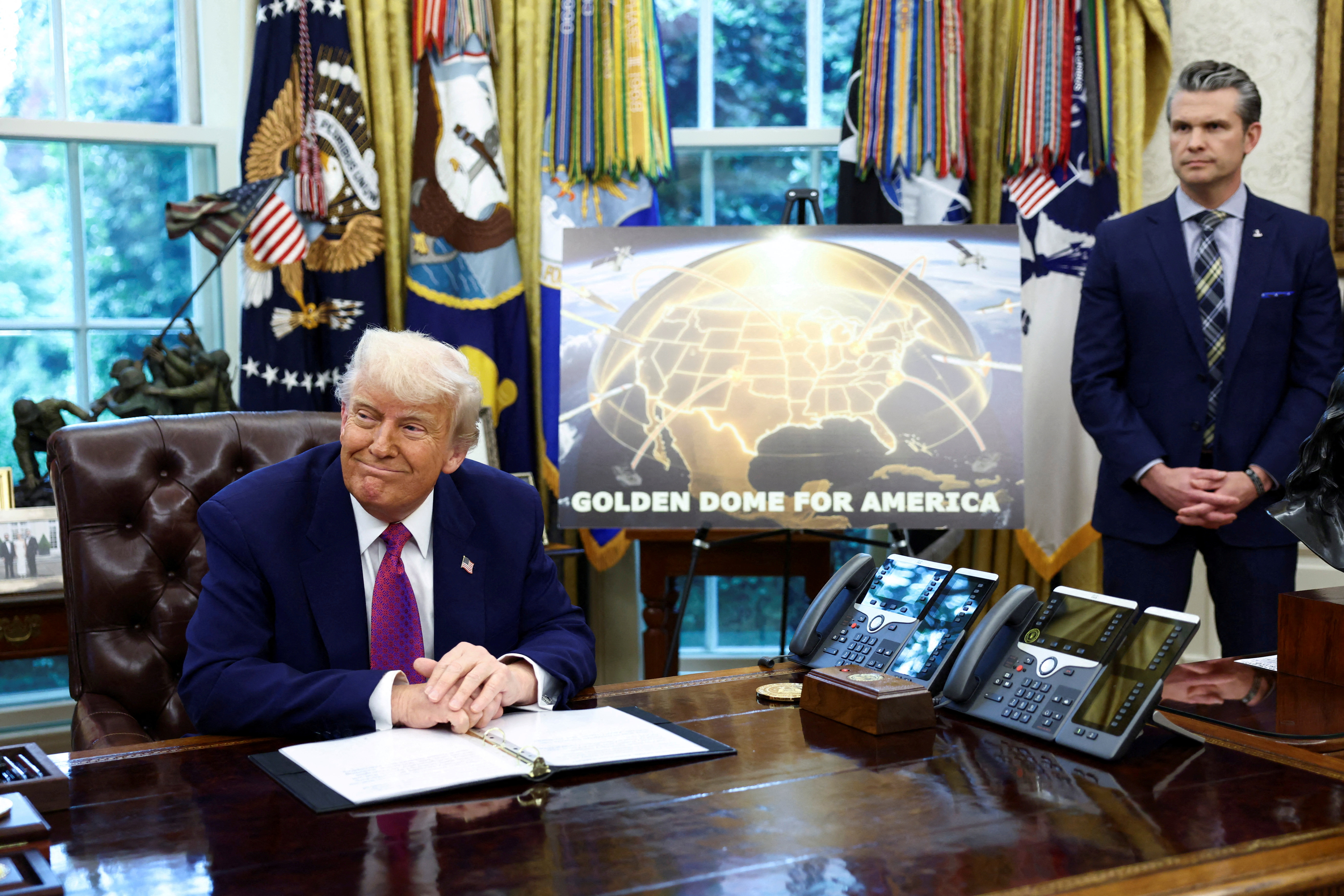 U.S. President Donald Trump and U.S. Defense Secretary Pete Hegseth make an announcement at the White House in Washington
