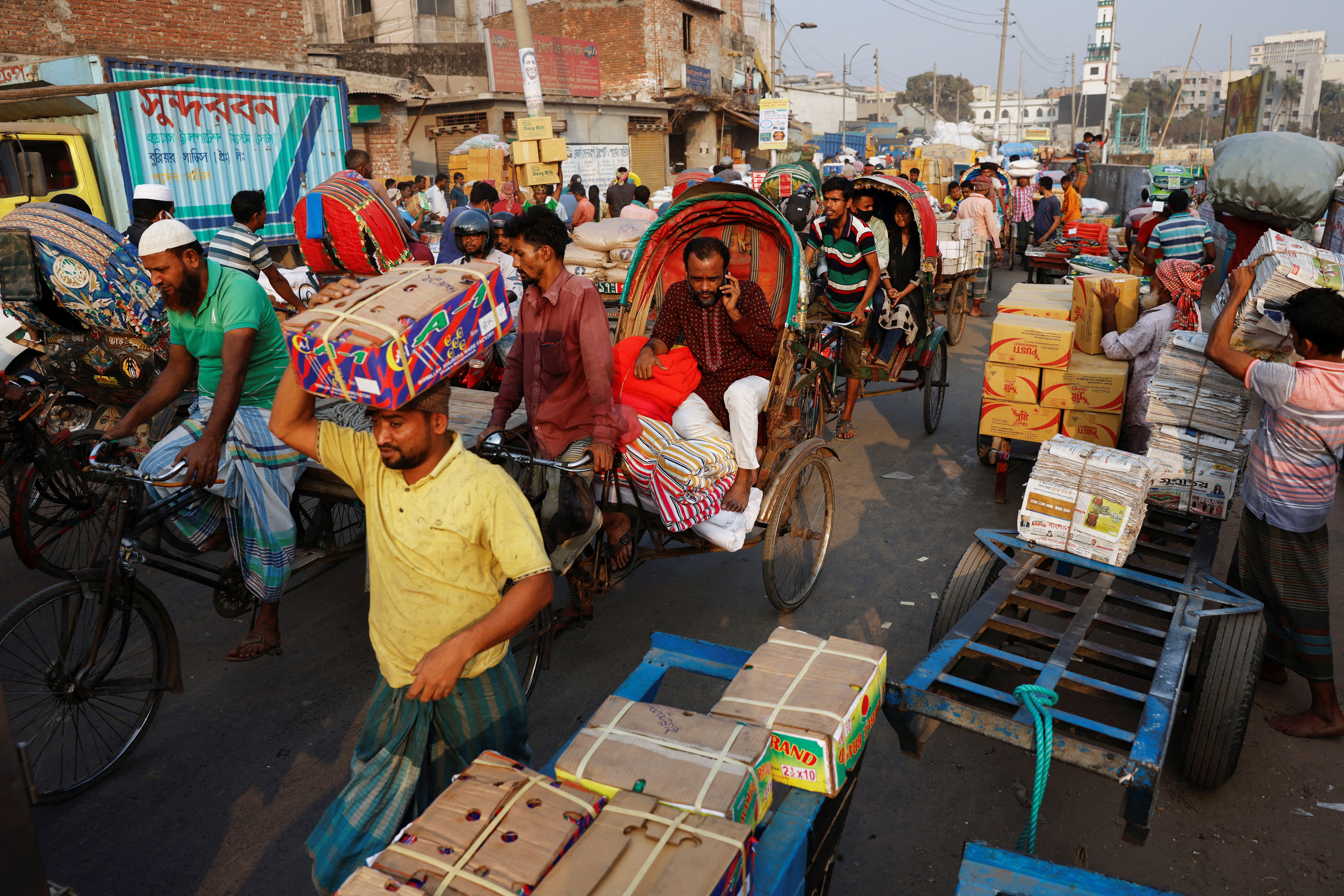 A man speaks over cell phone while stuck in traffic in Dhaka