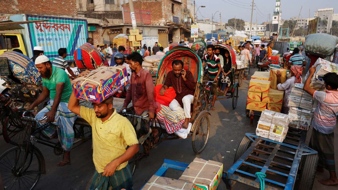 A man speaks over cell phone while stuck in traffic in Dhaka