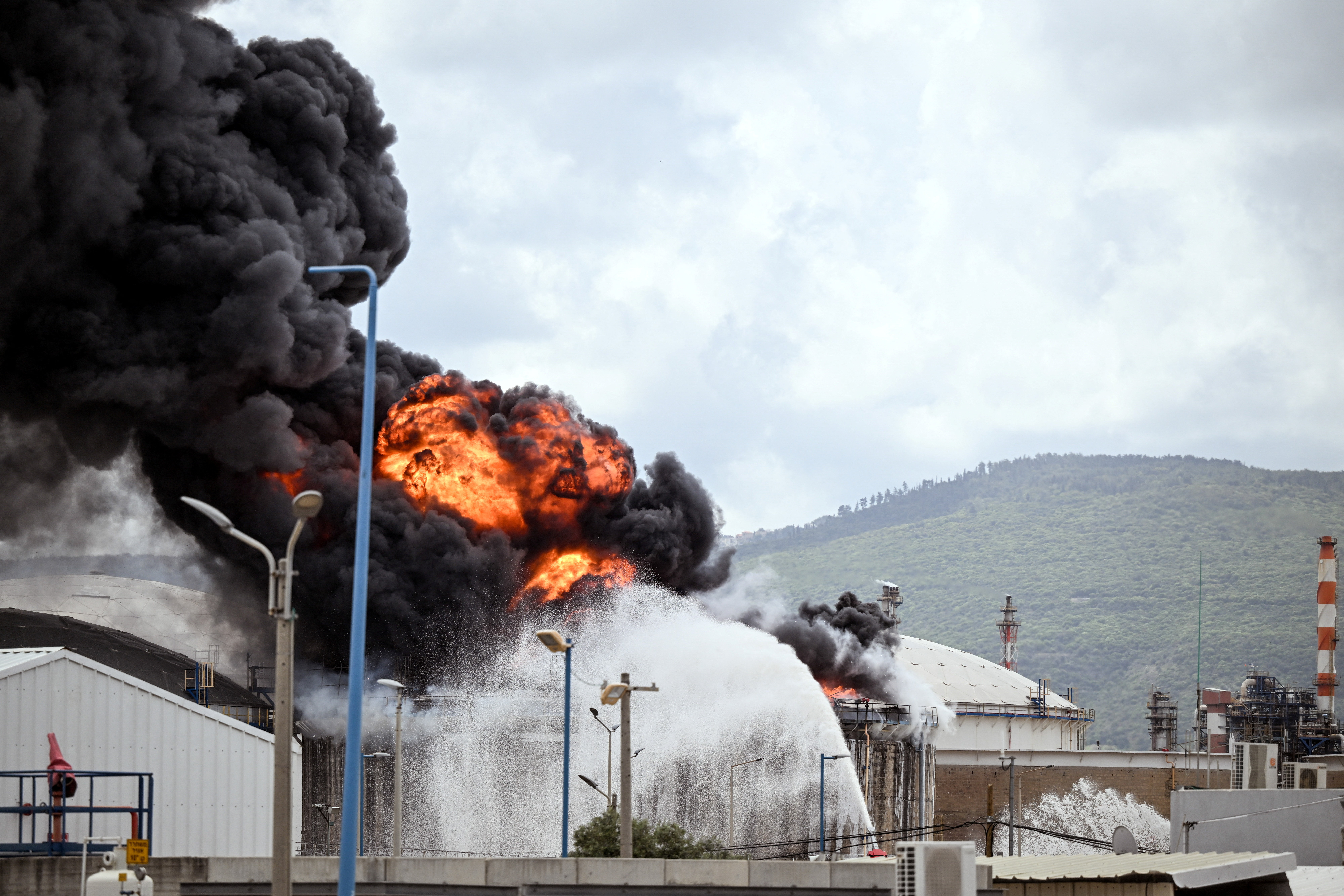 A blaze after Israel's Fire and Rescue Service said that an industrial building and a fuel tanker at Israel's Oil Refineries were hit by debris from an intercepted Iranian missile, in Haifa
