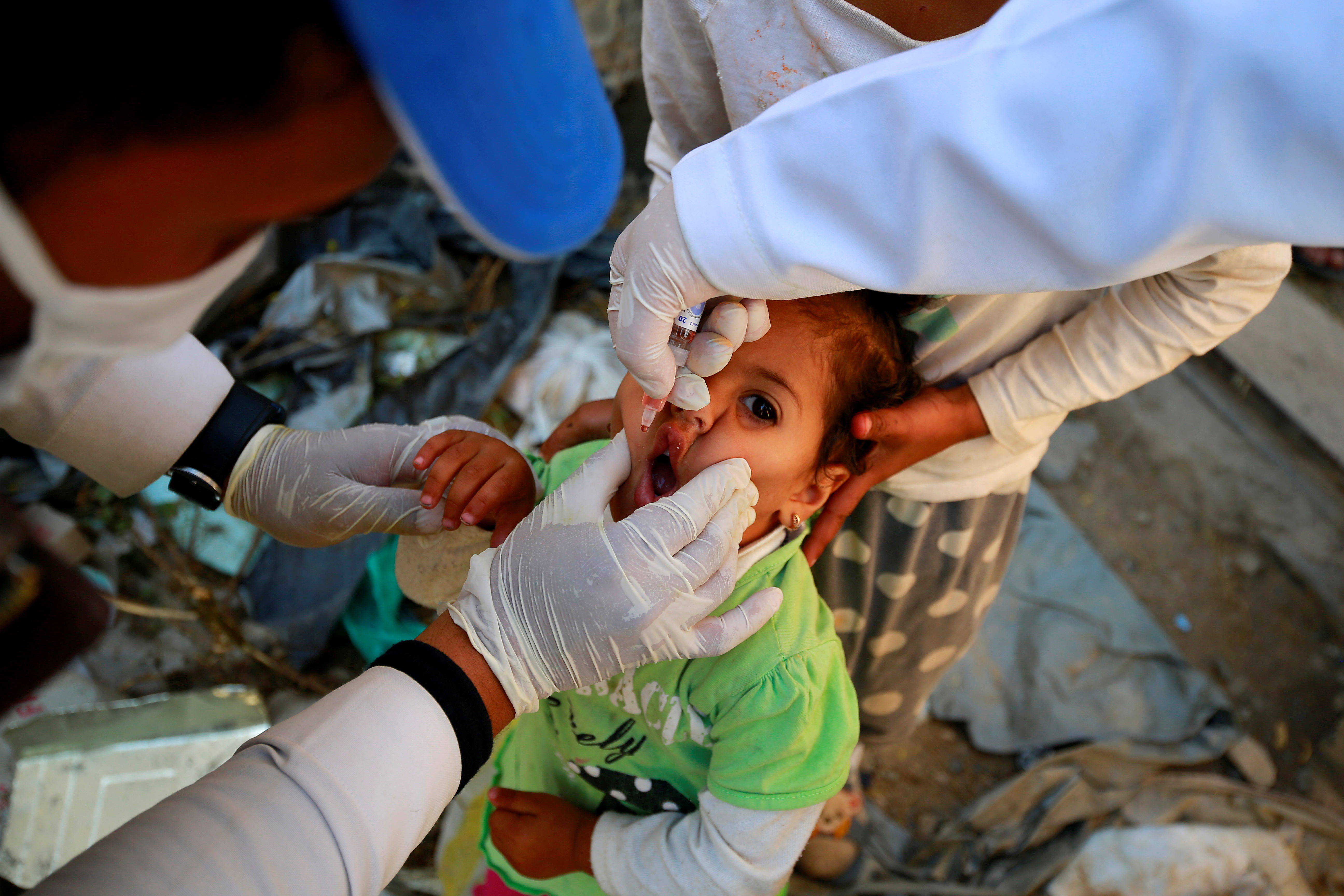 Girl receives a polio vaccine during a three-day immunization campaign in Sanaa