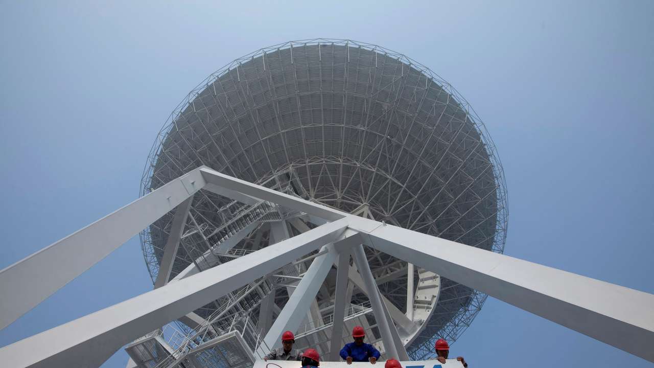 FILE PHOTO: Employees install a signage of the 54th Research Institute of CETC in Shanghai