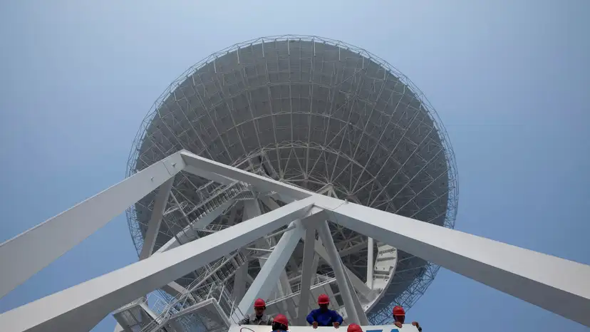 FILE PHOTO: Employees install a signage of the 54th Research Institute of CETC in Shanghai