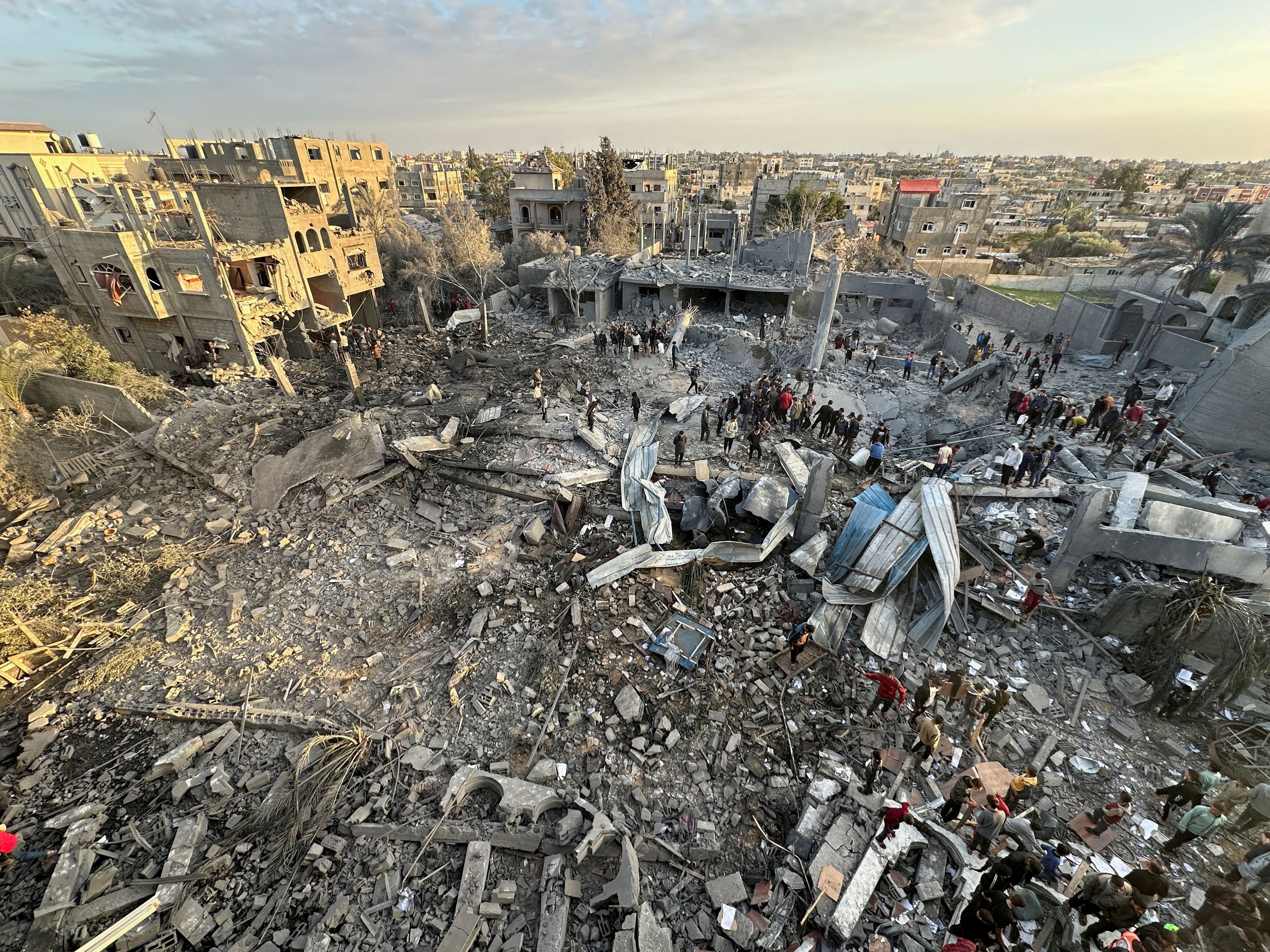 Palestinians inspect the site of an Israeli strike on a mosque, in Rafah