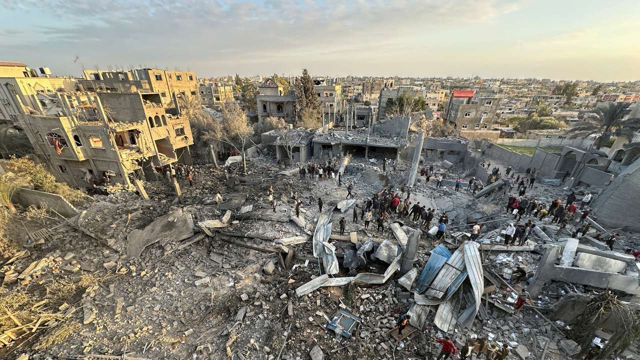 Palestinians inspect the site of an Israeli strike on a mosque, in Rafah