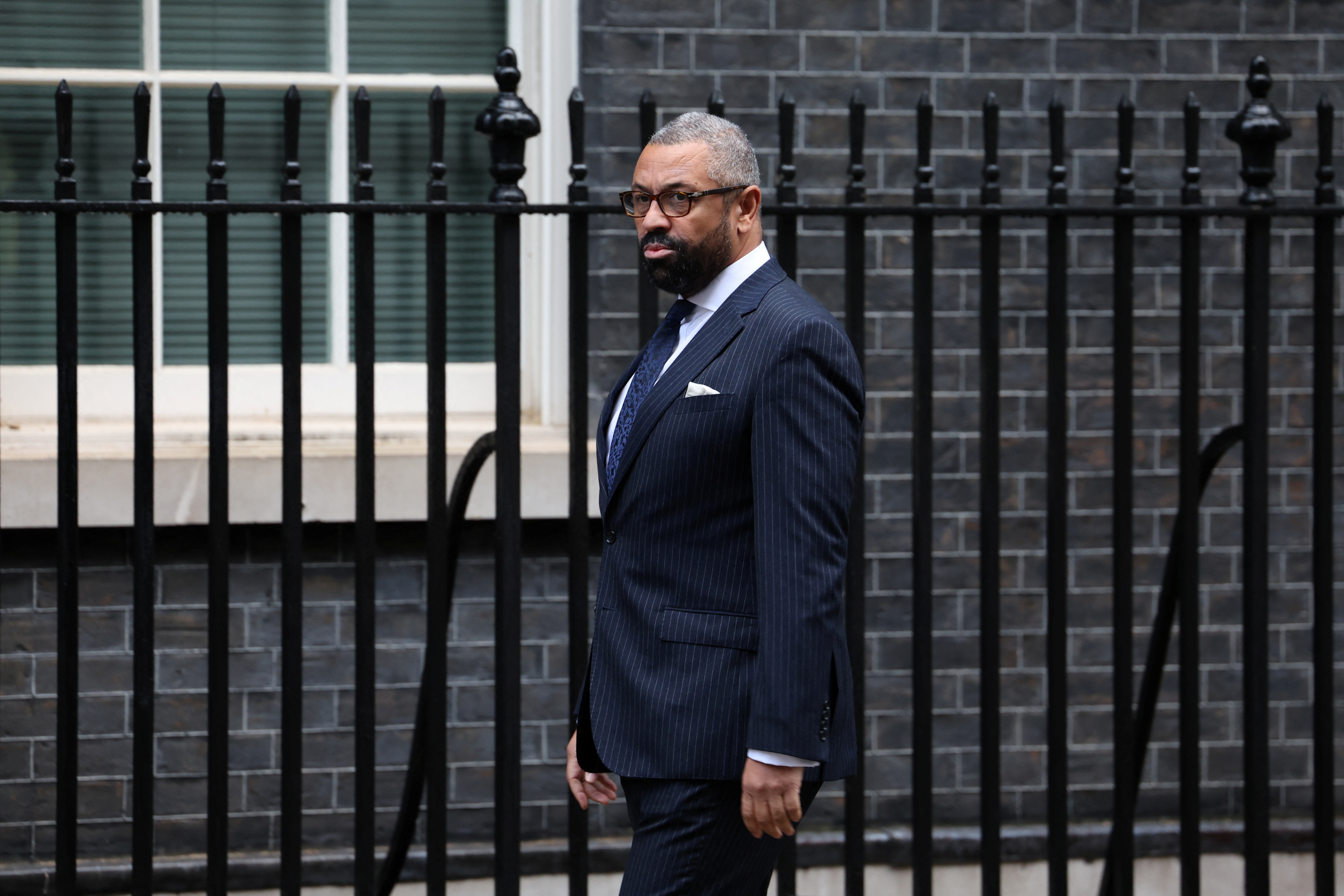 Britain's Foreign Secretary James Cleverly walks outside 10 Downing Street in London