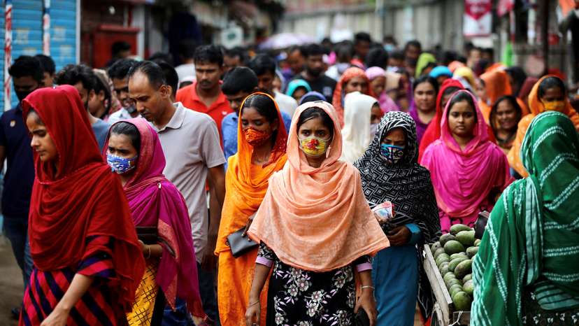 FILE PHOTO: Garment workers come out of a factory during the lunch break as factories remain open despite a countrywide lockdown, in Dhaka