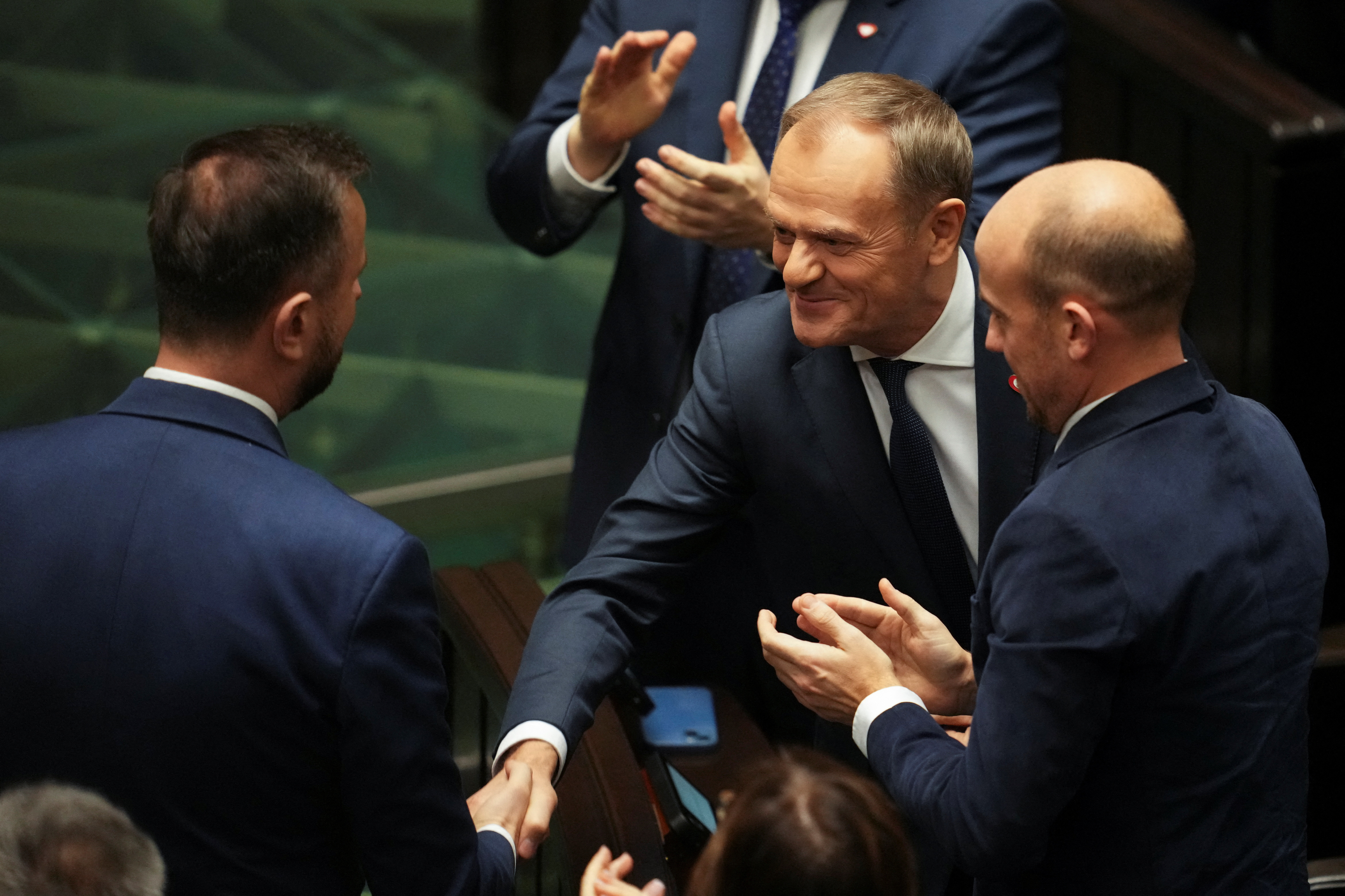 Leader of the Civic Coalition (KO) Donald Tusk shakes hands with leader of the Polish People's Party (PSL) Wladyslaw Kosiniak-Kamysz after the Parliament voted in favor of him becoming the Prime Minister, in Parliament, in Warsaw