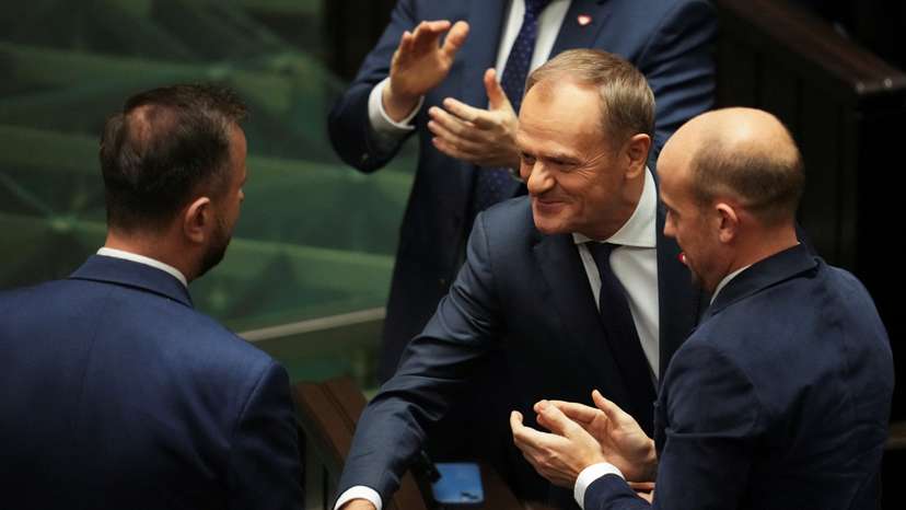 Leader of the Civic Coalition (KO) Donald Tusk shakes hands with leader of the Polish People's Party (PSL) Wladyslaw Kosiniak-Kamysz after the Parliament voted in favor of him becoming the Prime Minister, in Parliament, in Warsaw