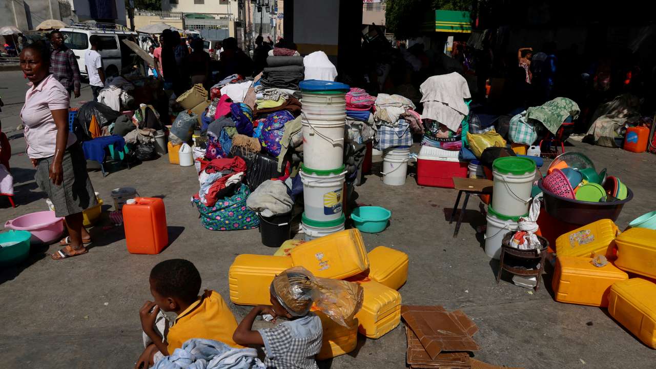 FILE PHOTO: People shelter at a petrol station amid ongoing gang violence
