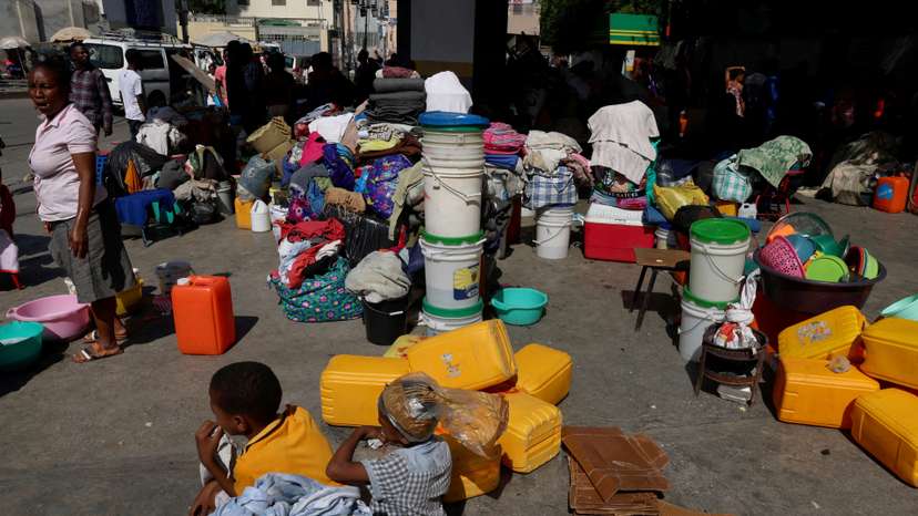 FILE PHOTO: People shelter at a petrol station amid ongoing gang violence