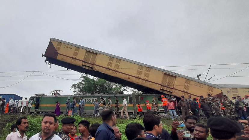 Rescue workers along with people gather at the site of a train collision after the accident in Darjeeling district in West Bengal state