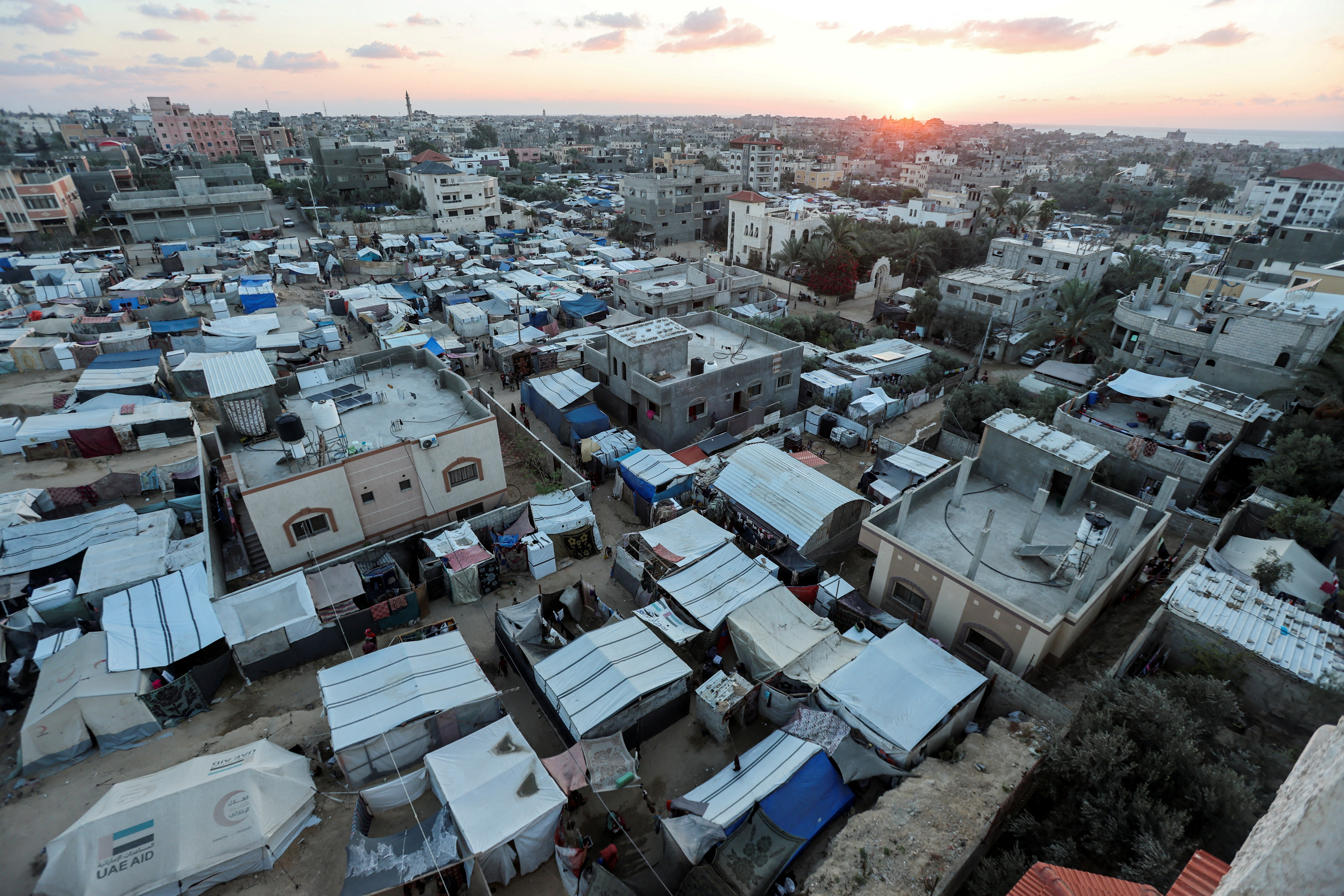 Displaced Palestinians shelter at a tent camp, in Deir Al-Balah
