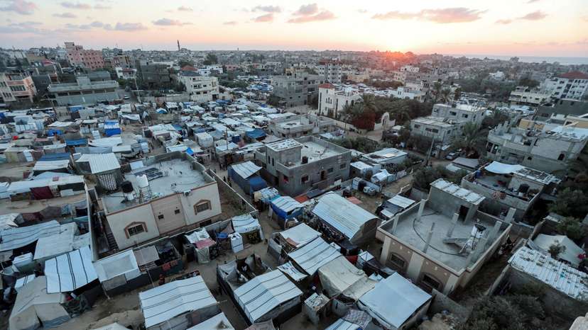 Displaced Palestinians shelter at a tent camp, in Deir Al-Balah